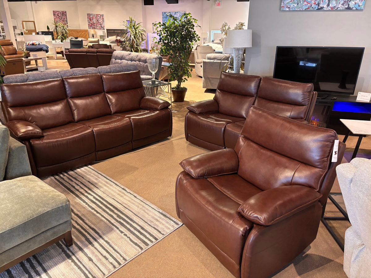 Model 9736BRW brown leather reclining sofa, loveseat, and recliner chair displayed in showroom