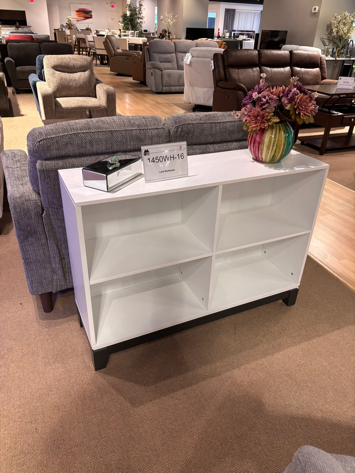 Model 1450WH-16 low white bookshelf with four open storage compartments and dark base
