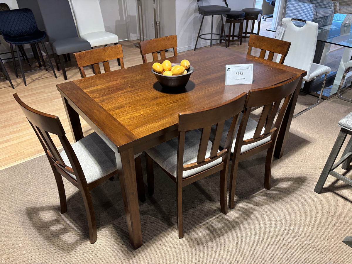 Model 5762 seven-piece dining set with warm brown wood table and upholstered dining chairs