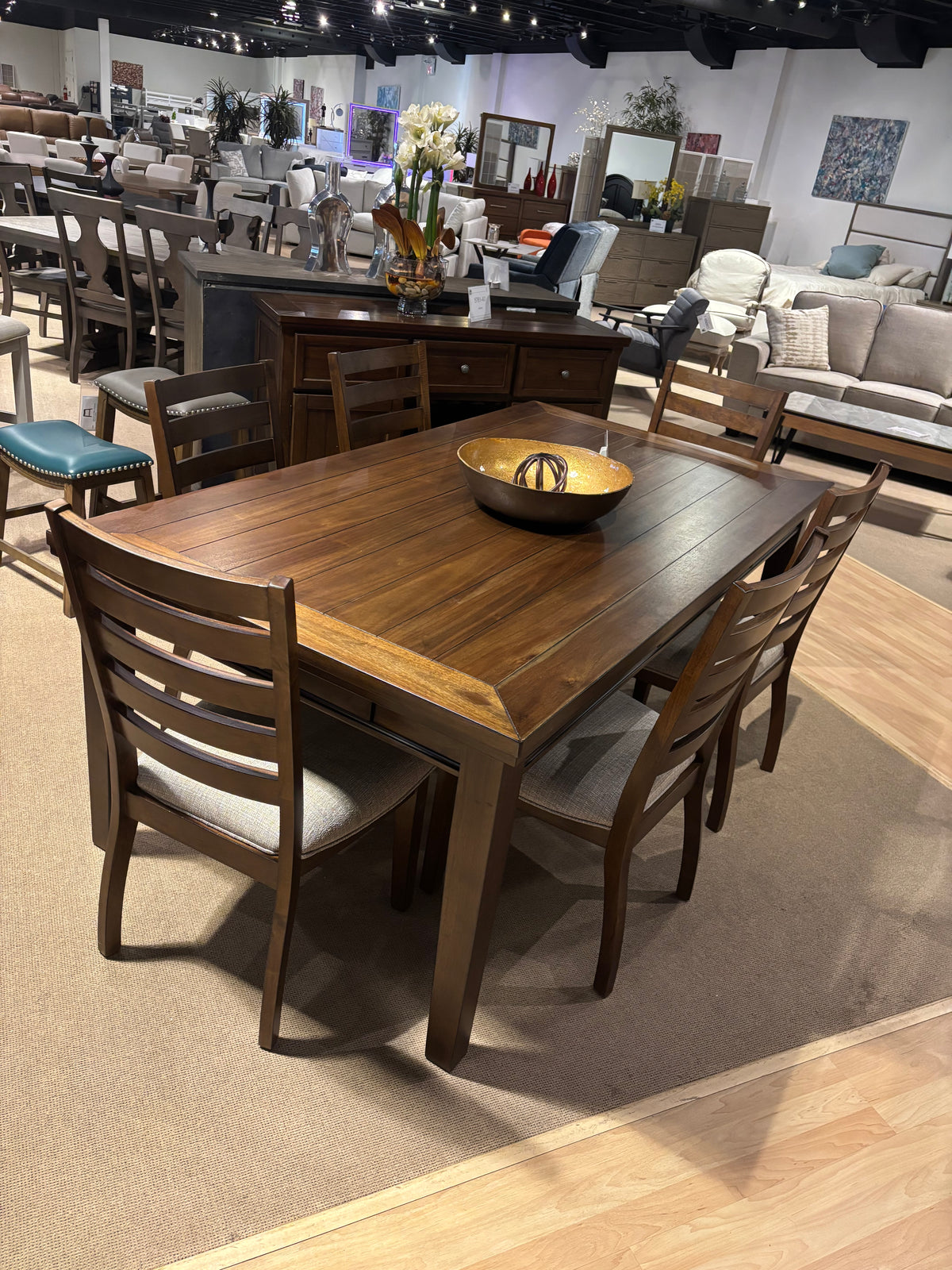 Model 5761 dining set with warm wood table and ladder-back upholstered chairs