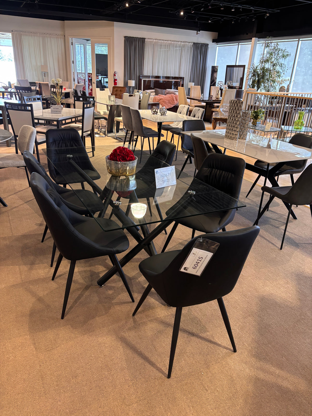 Model 6038 modern glass-top dining table with black upholstered chairs