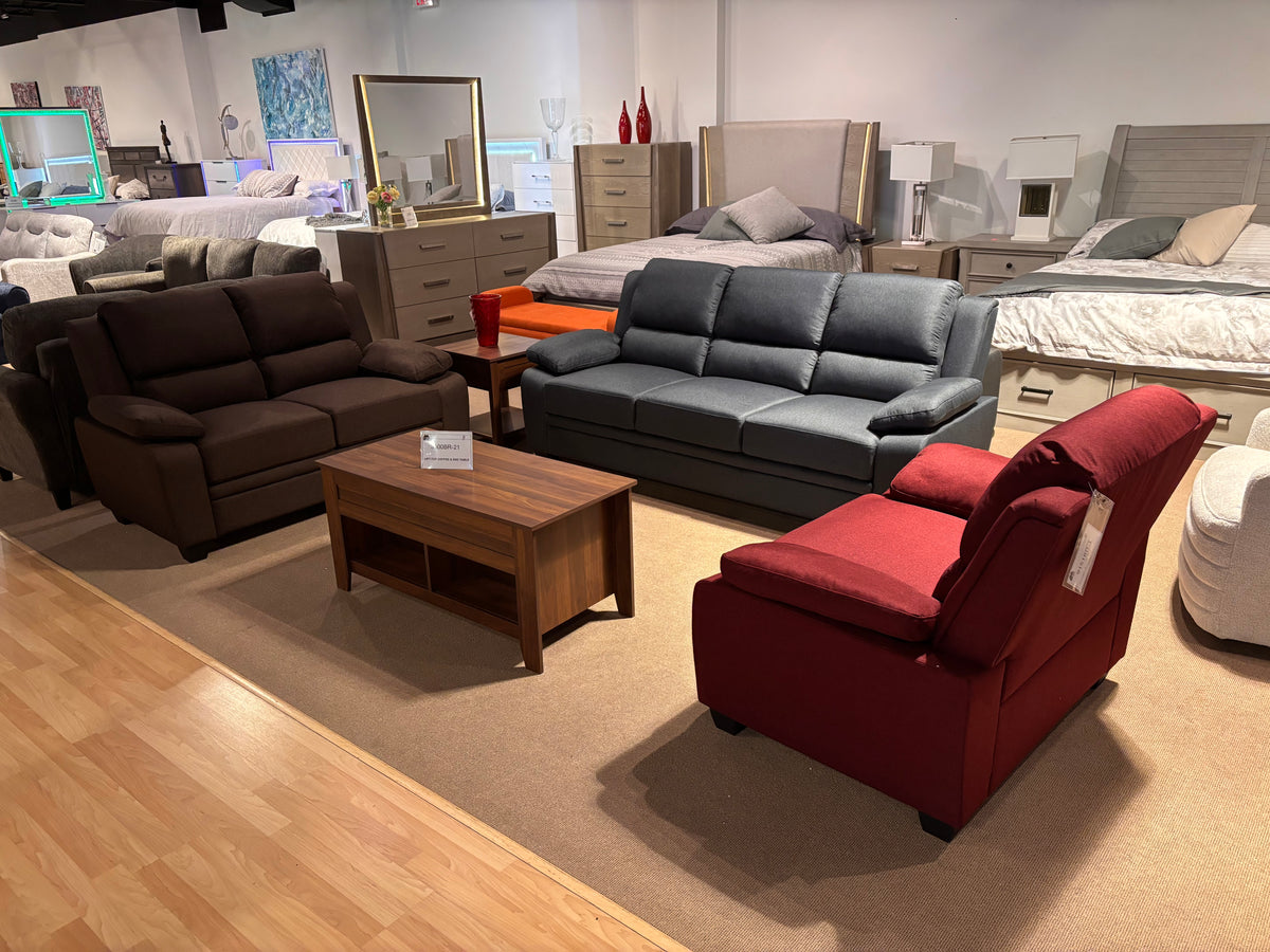 Model 9151 living room seating shown in three colors: brown, grey, and red, displayed in the showroom