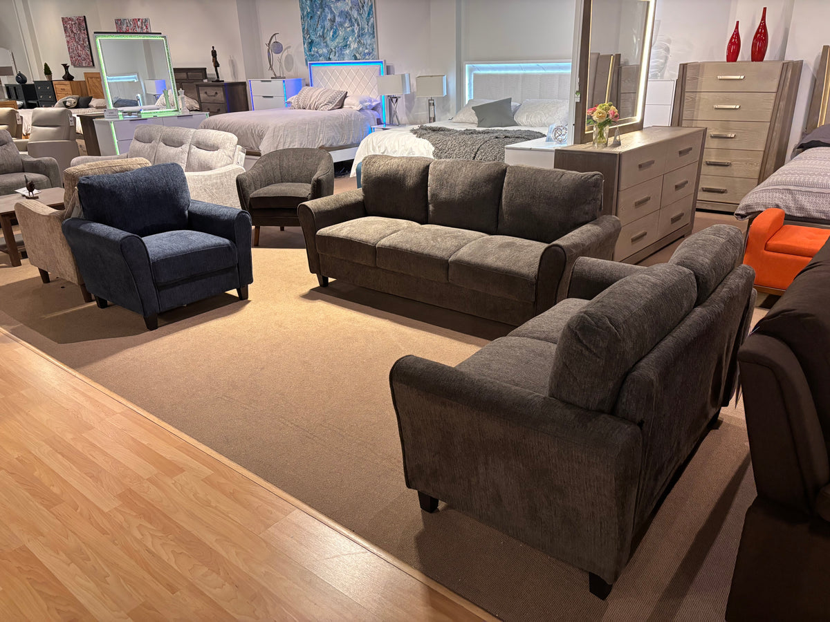 Model 9209NF grey living room set with sofa, loveseat, and blue accent chair in showroom