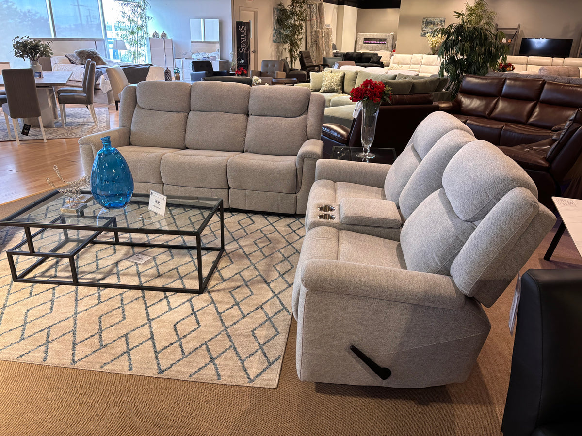 Model 99703GY grey reclining sofa and console loveseat displayed in showroom