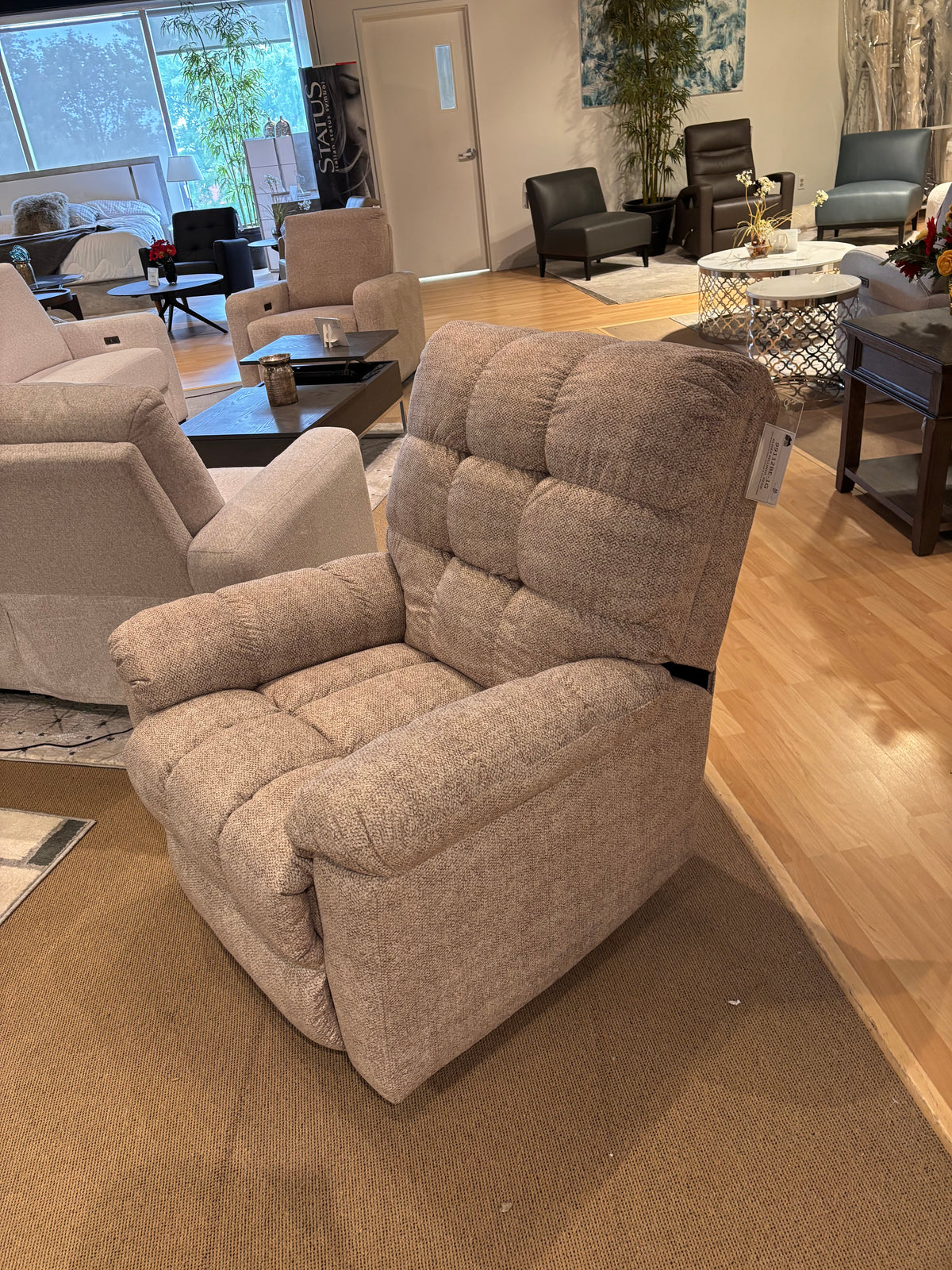 Model 99112 beige fabric recliner chair shown from the front in showroom