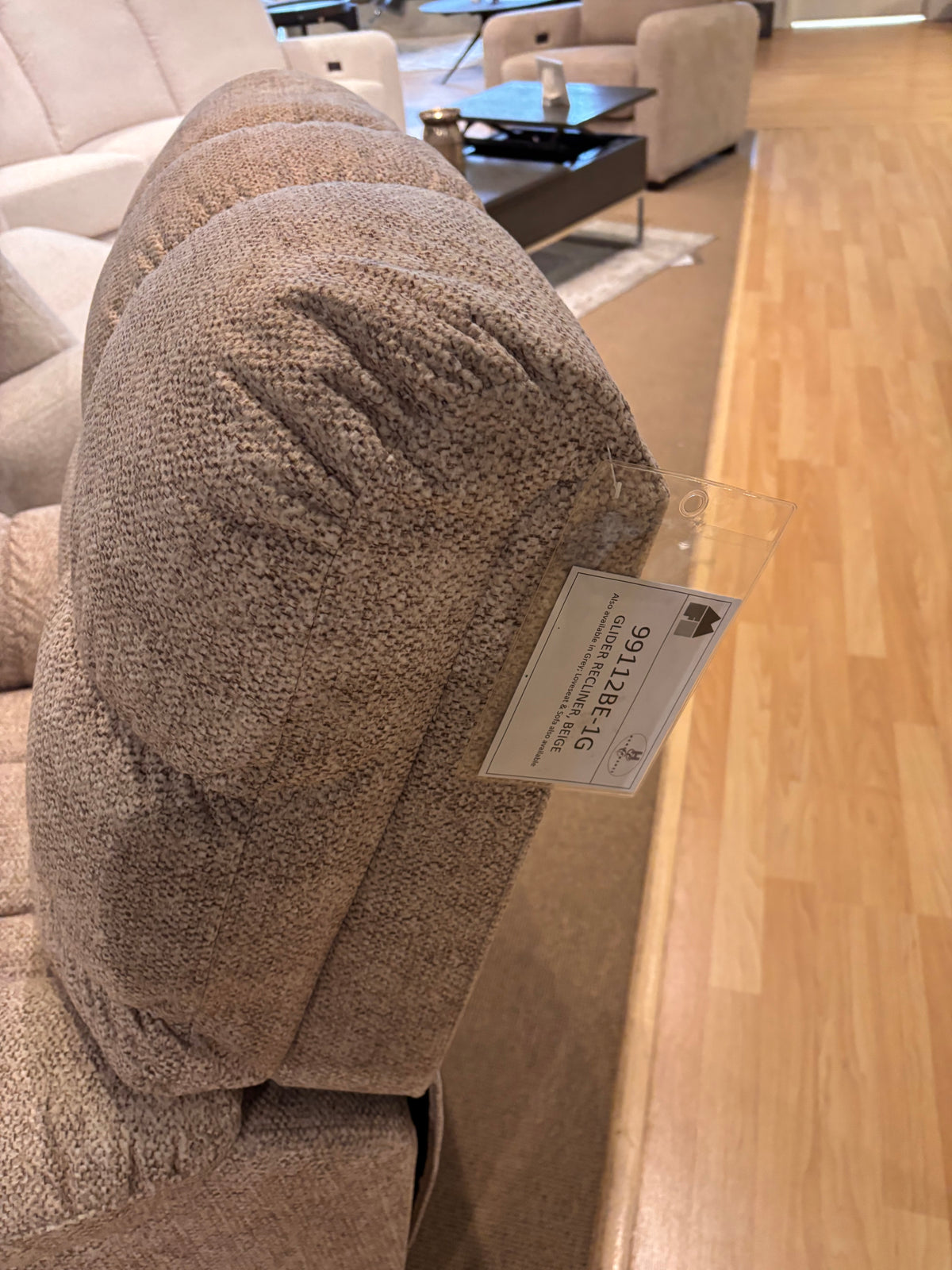 Model 99112 grey fabric reclining sofa and console loveseat displayed in showroom