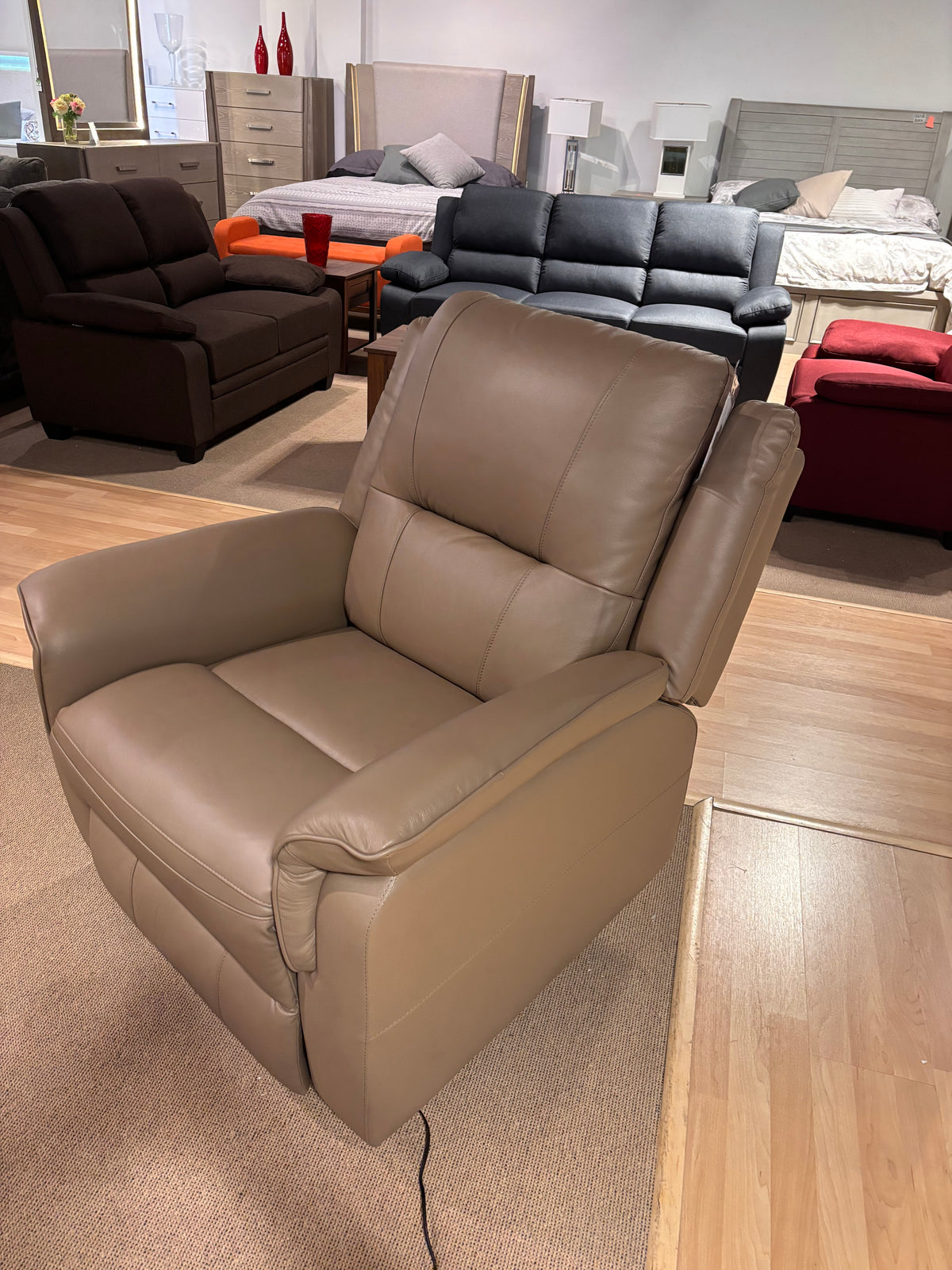 Model 8301 taupe electric power leather recliner chair displayed in showroom
