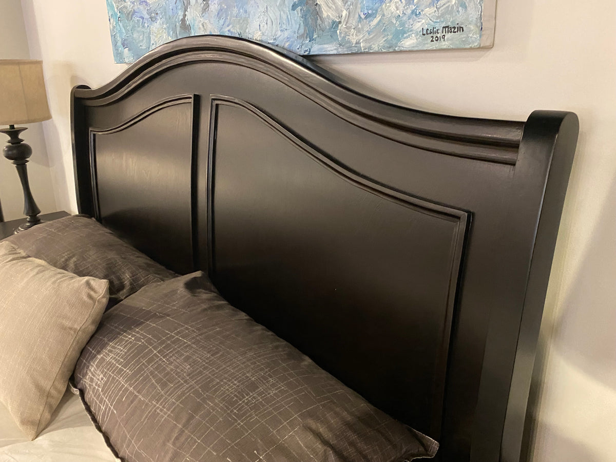 Model 1420 dark wood bedroom set with curved headboard, two-drawer storage footboard, and nightstands