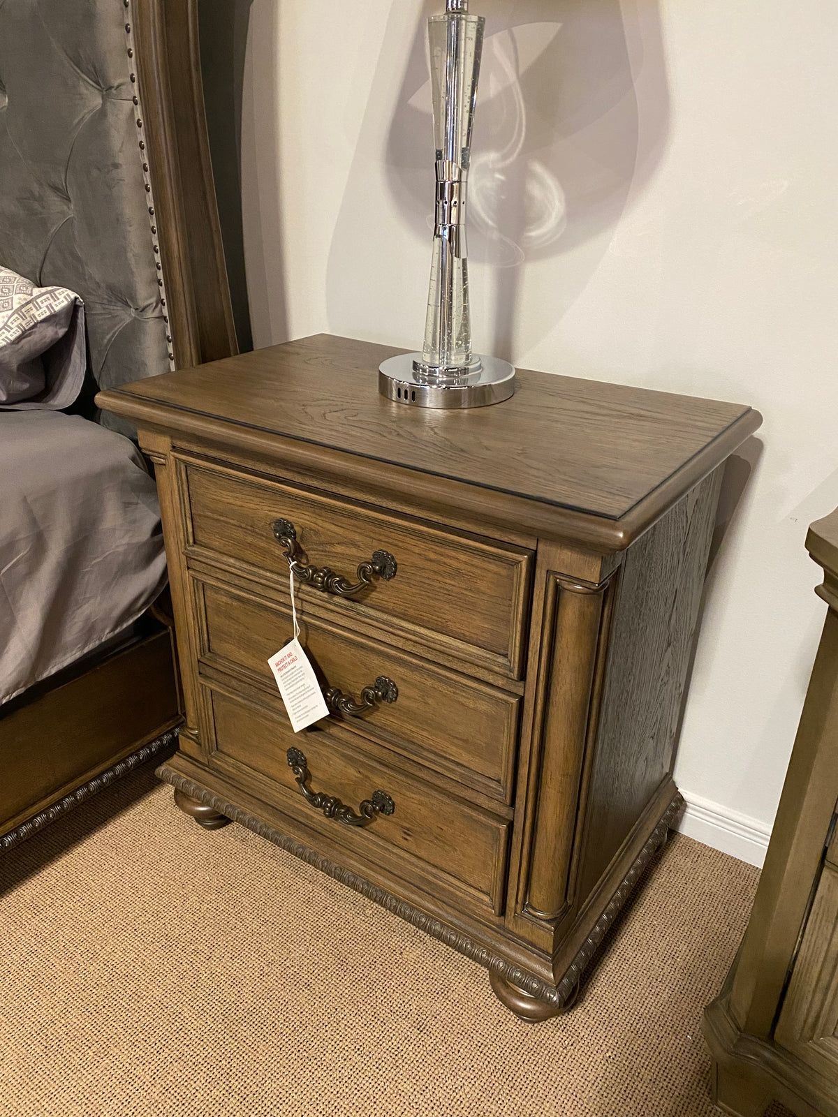 Model 1693 traditional three-drawer wood nightstand with ornate metal handles and carved trim