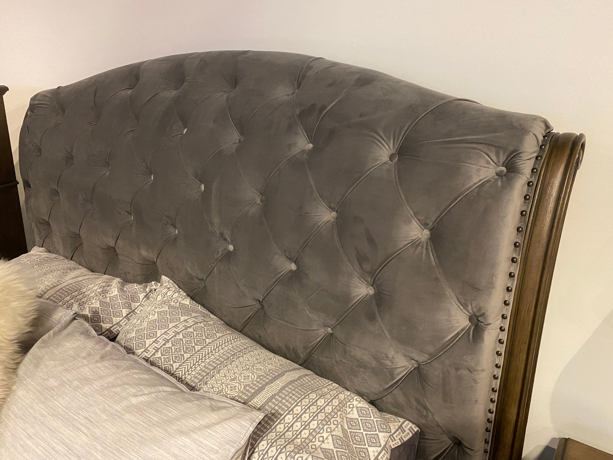 Close-up of Model 1693 grey velvet button-tufted wingback headboard with nailhead trim
