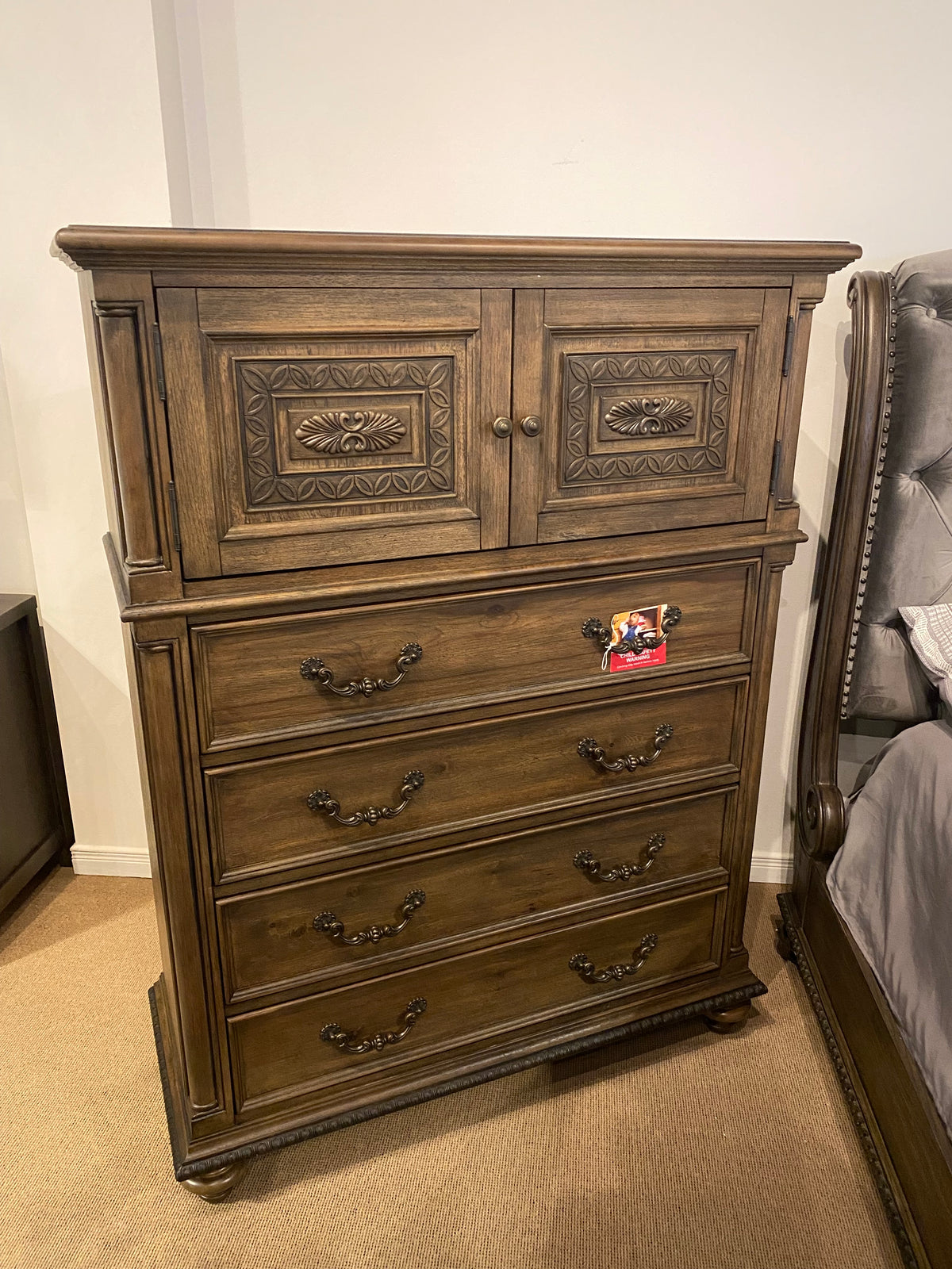 Model 1693 traditional wood door chest with carved cabinet doors, four lower drawers, and ornate handles