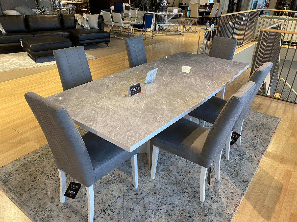 Model Mara Italian dining set alternate showroom view with marble-look table and grey chairs