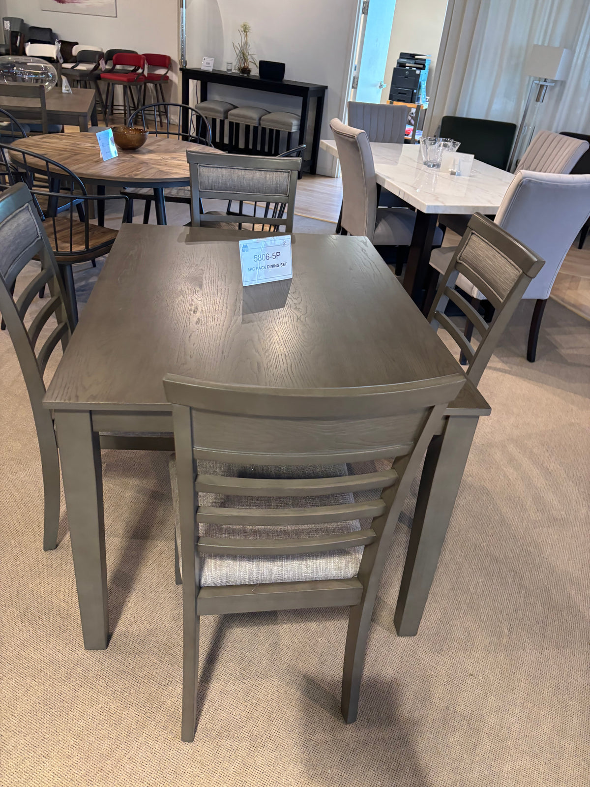 Model 5806 grey dining table and upholstered ladder-back chairs close view